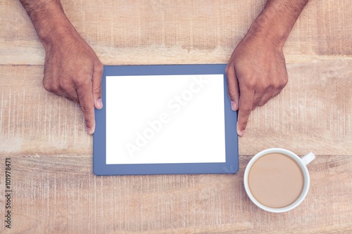 Overhead view of hand holding on digital tablet