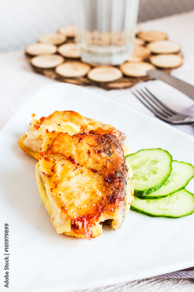 fried mackerel, fish in batter with a fresh cucumber fried mackerel, fish in batter with a fresh cucumber