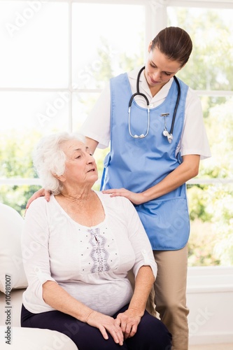 Nurse taking care of sick elderly woman  photo