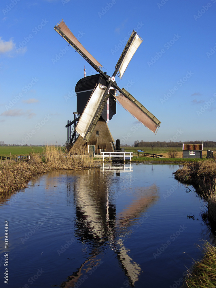 Dutch windmill reflected in water, Streefkerk, South Holland, Netherlands