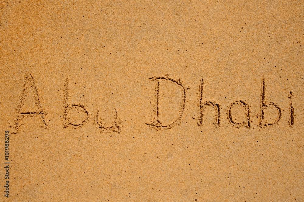 Fototapeta premium abu dhabi written in the sand