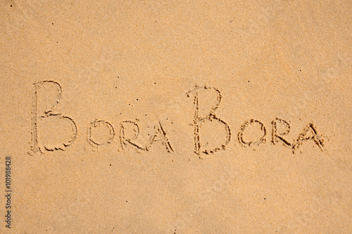 Bora Bora sign on sand, as background