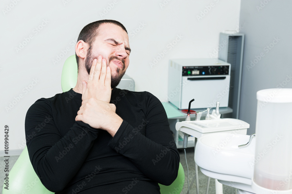Young patient at dentist feeling teeth pain Young patient at dentist feeling teeth pain