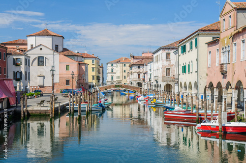 View over channel witn boats  houses and reflections in Chioggia