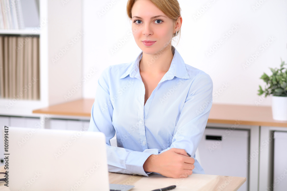 Young blonde business woman with laptop in the office. Business concept. Young blonde business woman with laptop in the office. Business concept.