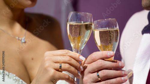 Couple, man and woman, drinking champagne in a fine dining restaurant, each with glass of sparkling wine in hand