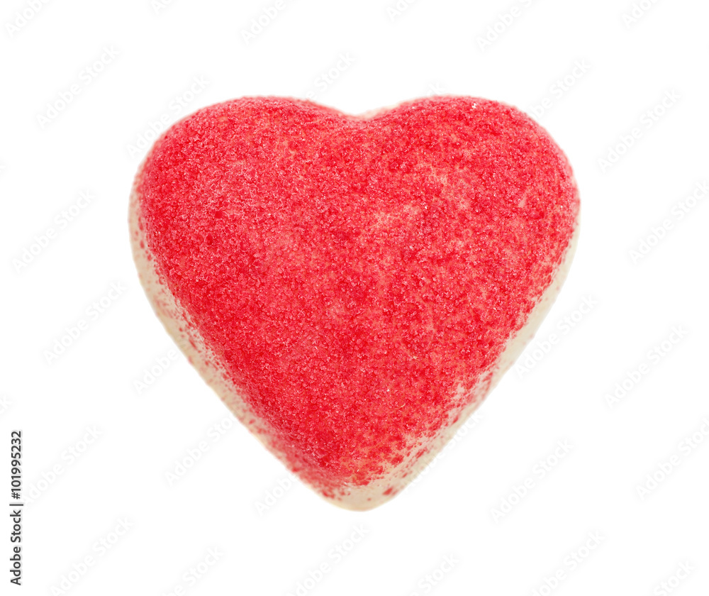The candy from white chocolate in the form of heart strewed with a red sugar crumb, isolated on the white