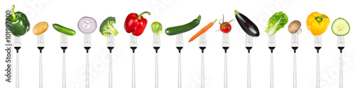 row of tasty vegetables on forks isolated on white background © stockphoto-graf