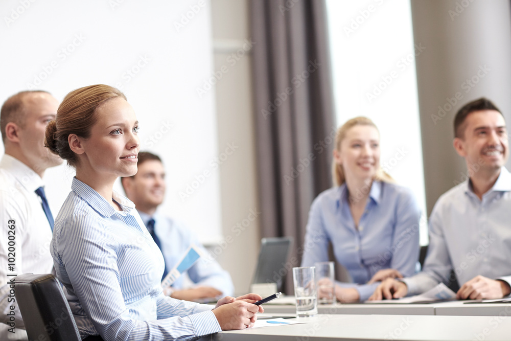group of smiling businesspeople meeting in office group of smiling businesspeople meeting in office
