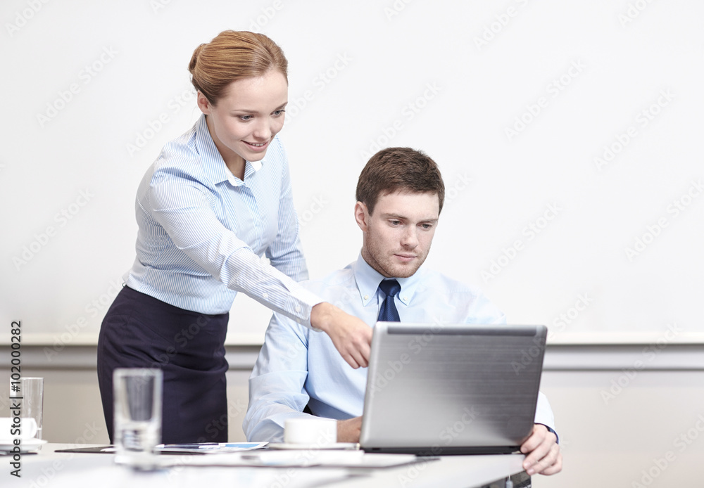 businessman and secretary with laptop in office businessman and secretary with laptop in office