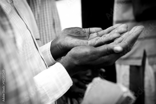 hands of man praying in South Sudan