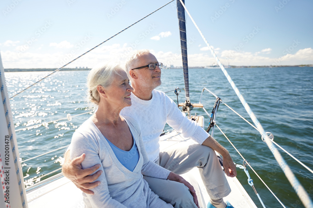 senior couple hugging on sail boat or yacht in sea senior couple hugging on sail boat or yacht in sea
