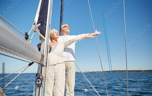 senior couple enjoying freedom on sail boat in sea
