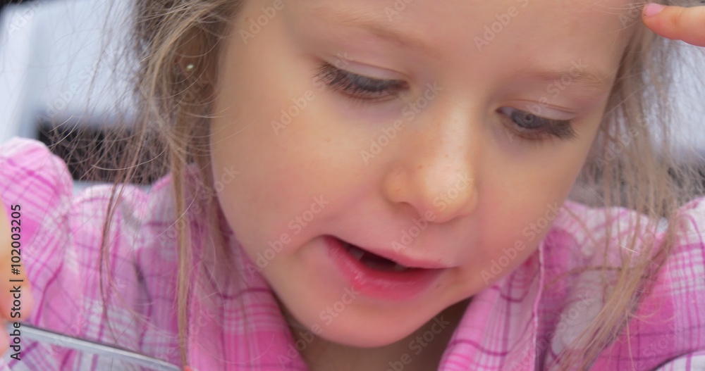 Little Blonde Girl Face Close Up is Sitting Chair Table Eating the Red Soup Borsch in Cafe Girl Doesn't Like the Food Outdoors Green Creeping Plant Little Blonde Girl Face Close Up is Sitting Chair Table Eating the Red Soup Borsch in Cafe Girl Doesn't Like the Food Outdoors Green Creeping Plant