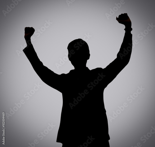 Silhouette of man showing his hand on soft brown background, Successful business concept.