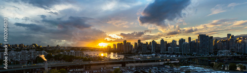 panoramic view of the buildings of vancouver city skyline and a marina during a beautiful sunset