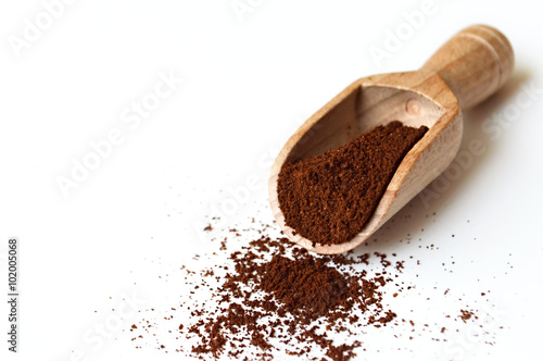 Ground coffee in wooden scoop photo