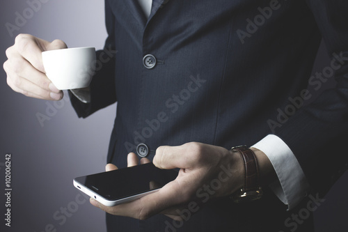 man hand phone and coffee cup