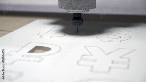 Milling cutting machine makes a plotter cutting in plastic currency FRANK signs