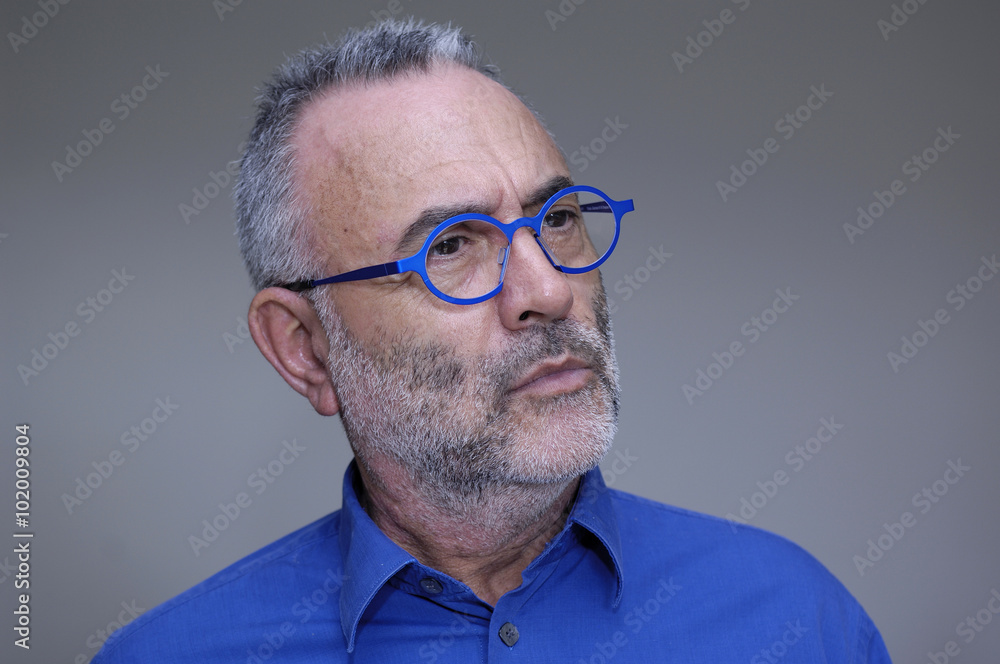 man in glasses and blue shirt staring, man in glasses and blue shirt staring,
