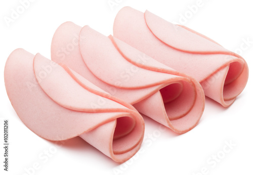 cooked boiled ham sausage or rolled bologna slices isolated on w photo