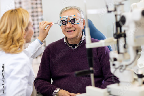 Ocular specialists work with patient on eye clinic