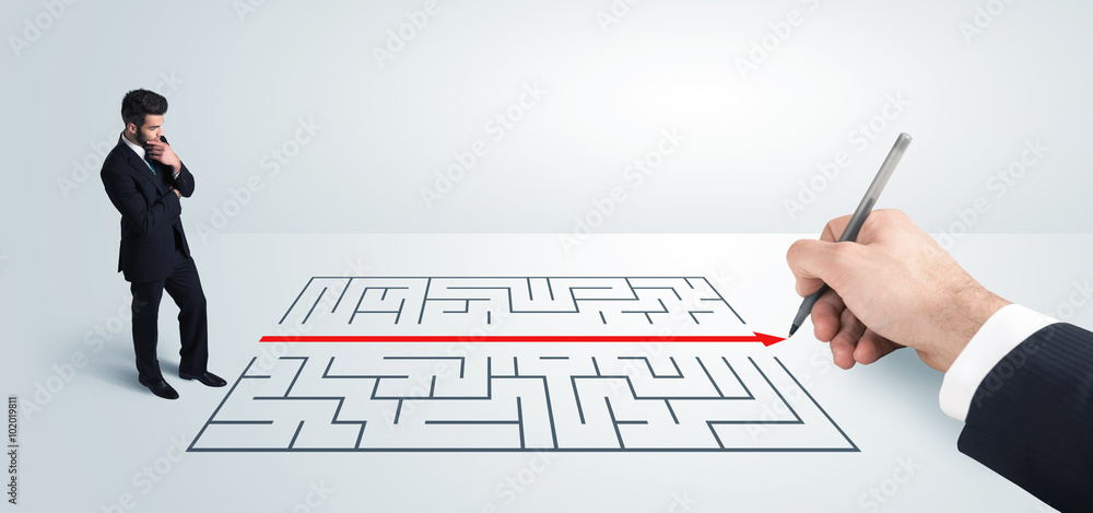 Business man looking at hand drawing solution for maze Business man looking at hand drawing solution for maze