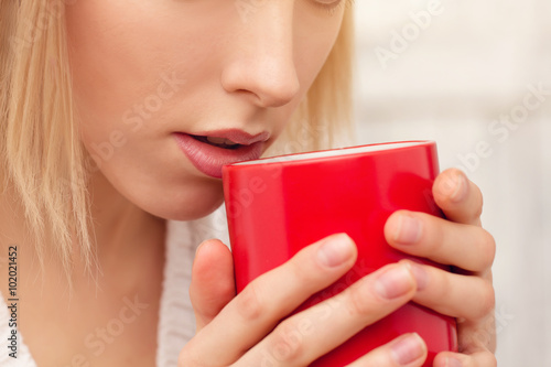Lady with a cup of tea indoors