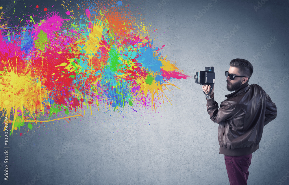 Hipster guy with camera and paint splash - obrazy, fototapety, plakaty 