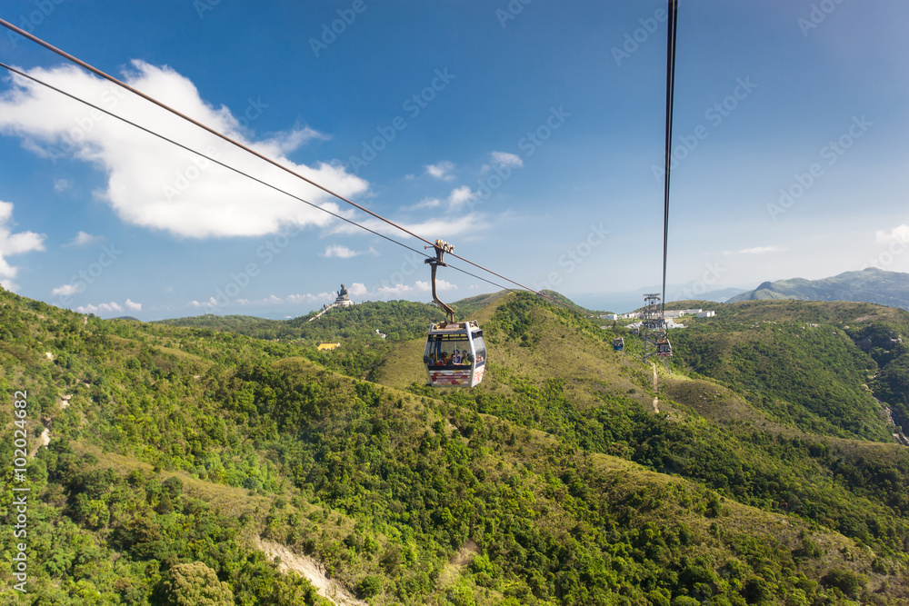 Cable Car way to mountains with statue of buddha