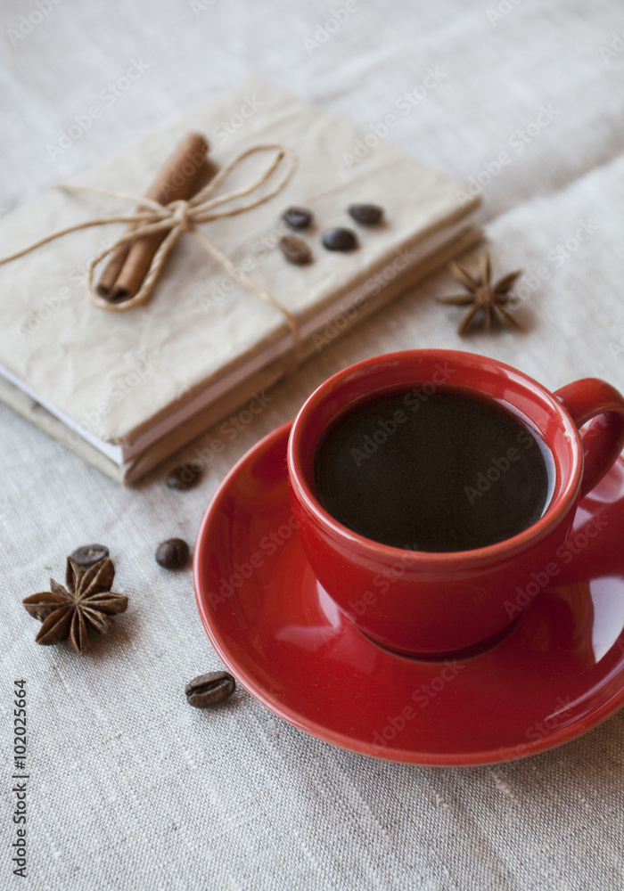 Red cup of coffee with coffee beans and spices cinnamon Red cup of coffee with coffee beans and spices cinnamon