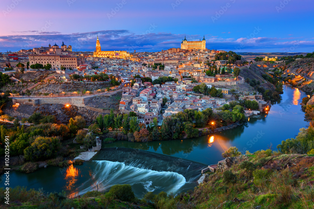 Great panoramic of historic city of Toledo at night, Spain. The Alcazar on the right and Cathedral on the left dominate the skyline