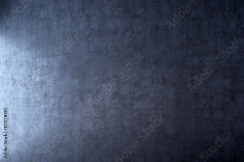 Dark wall with light effect in blue plaster