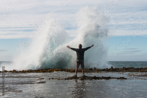 Man in front of splashing wave