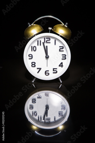 Alarm clock with dark background and reflection