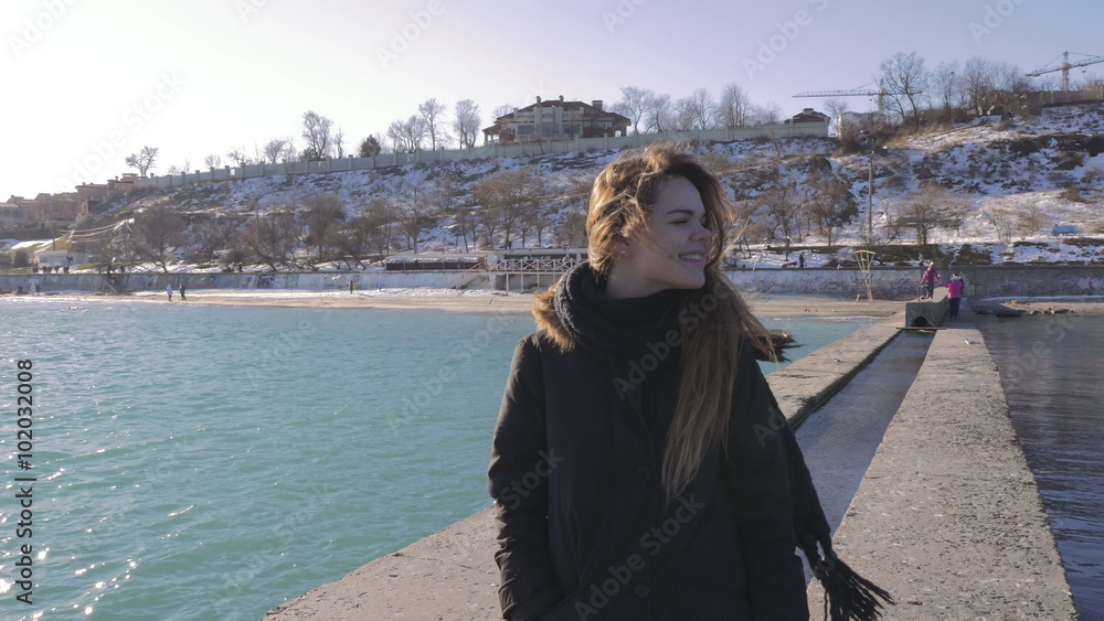 Young woman smiling and looking around on sea pier, 4k Young woman smiling and looking around on sea pier, 4k