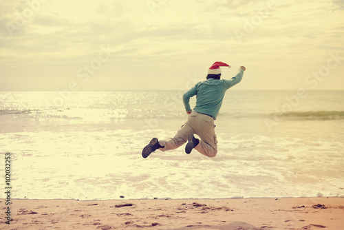 Super man on beach. Santa Claus flying over sea beach and sky