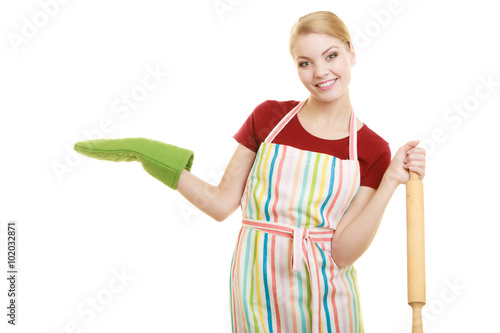 housewife holds baking rolling pin showing open palm