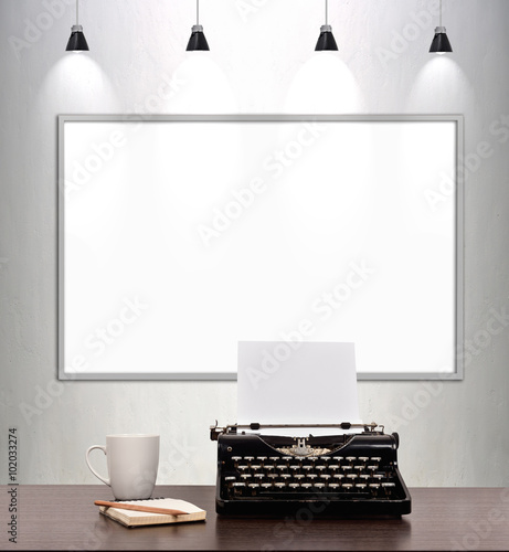 typewriter and blank placard on wall