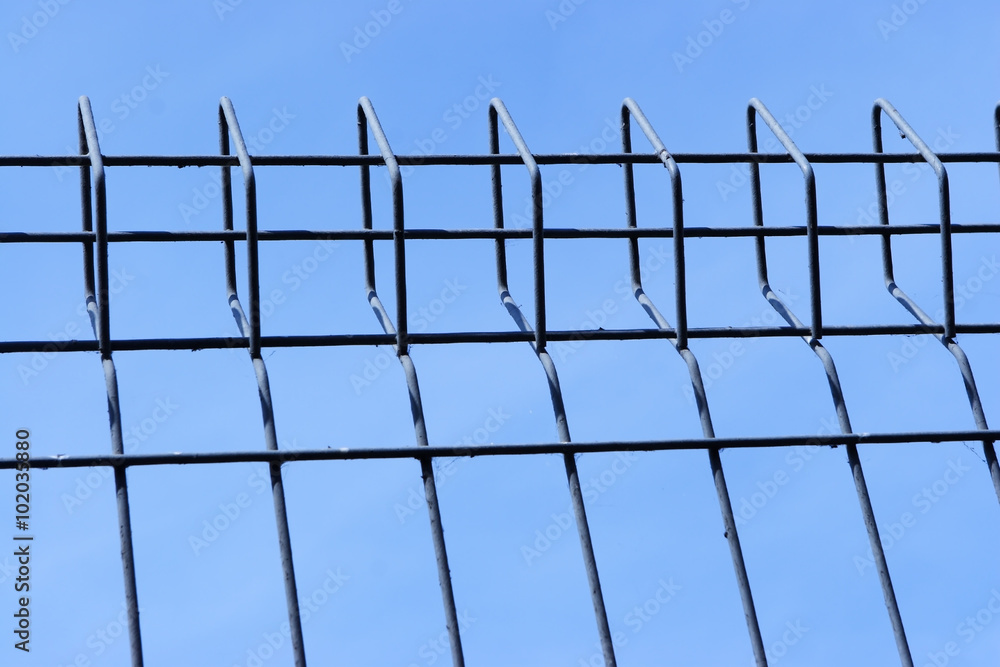 metal fence over blue sky. metal fence over blue sky.