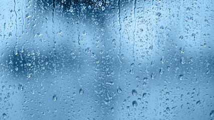 Raindrops on the window. Blue tone