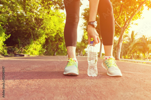 Fitness woman training and jogging in summer park