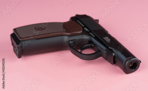 Air gun on pink background photo