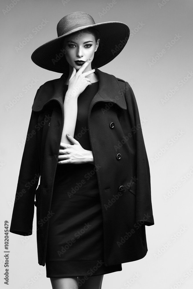 high fashion portrait of elegant woman in black hat and coat. high fashion portrait of elegant woman in black hat and coat.