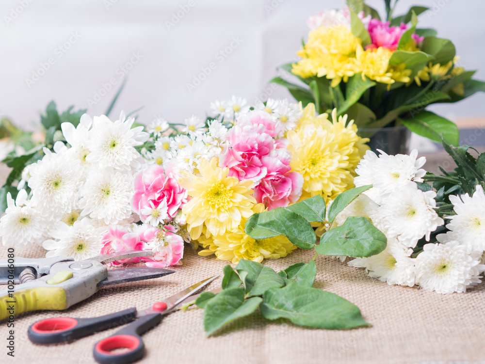 Scissor on table of flowers arrangement. Scissor on table of flowers arrangement.