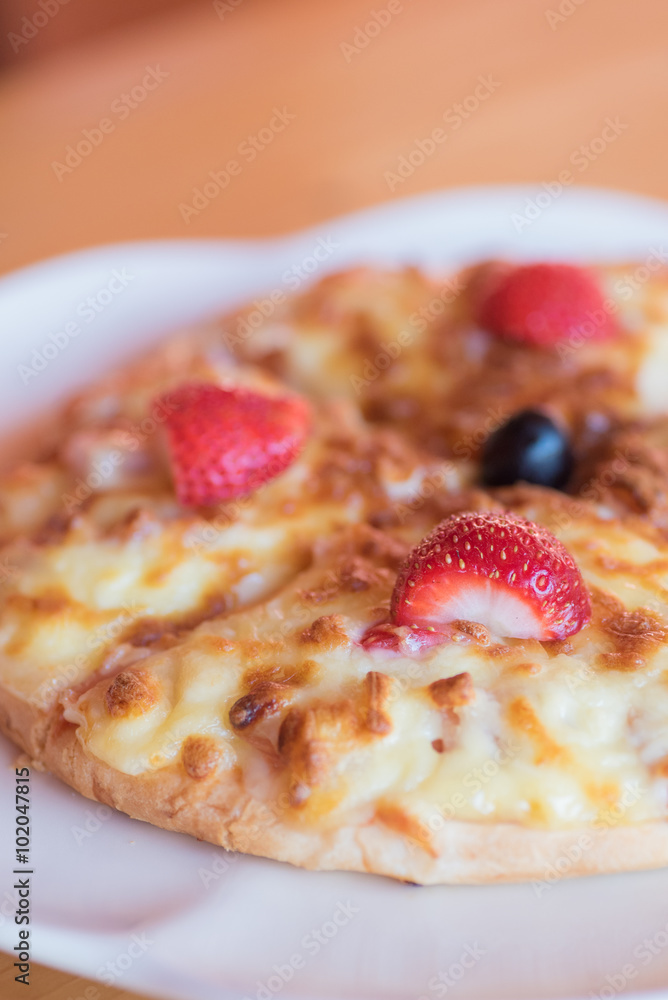 Delicious strawberry pizza on white plate