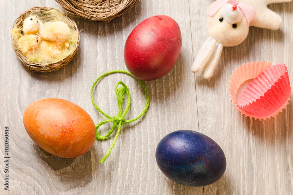 easter concept with colorful edible eggs, nest with chick and bu