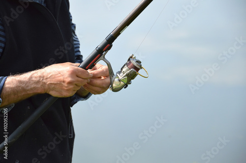 fisherman prepares bait for fish
