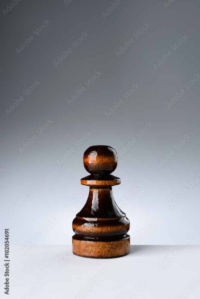 Black pawn on a white table Black pawn on a white table