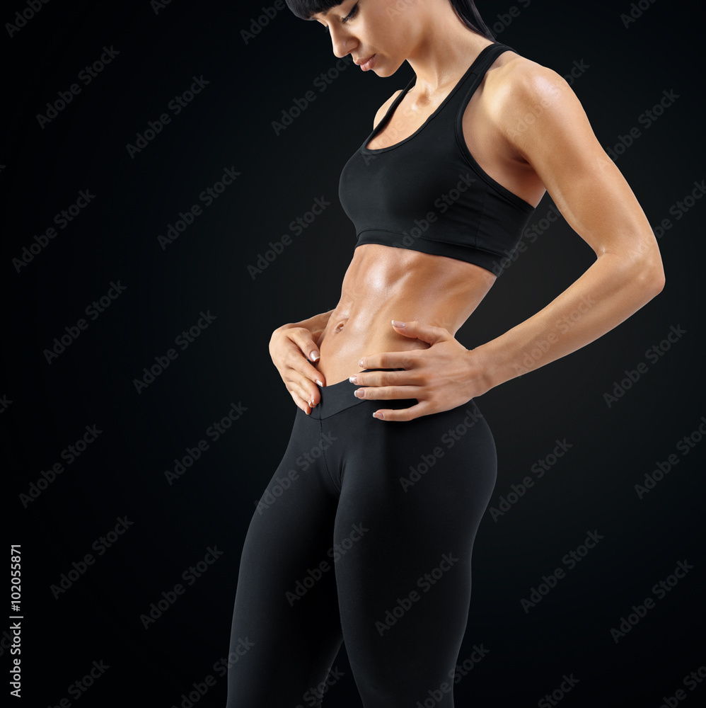 Fototapeta premium Close up of woman body strong abs showing